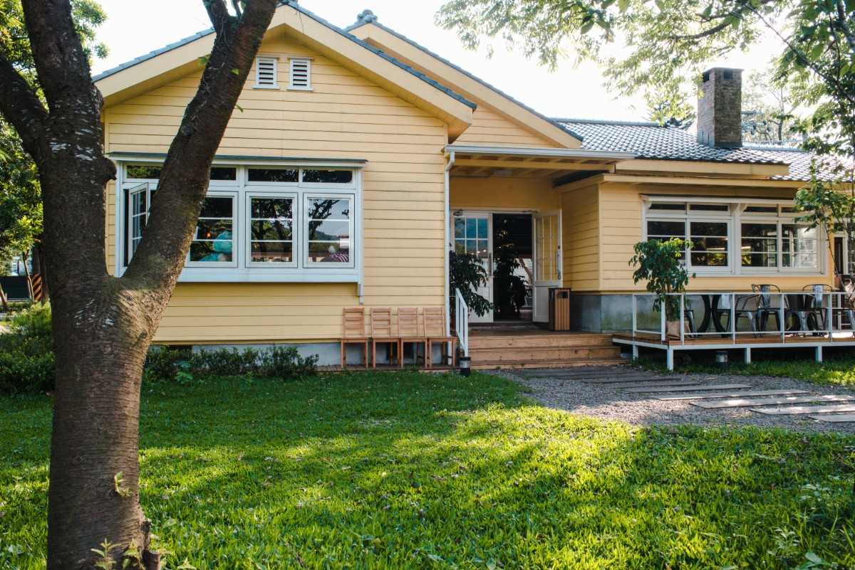 charming-yellow-house-with-wooden-windows-green-grassy-garden-150kb